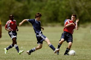 Three Men Playing Soccer